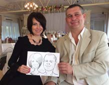 Ира и Юра держат шарж от шаржиста Мишеля