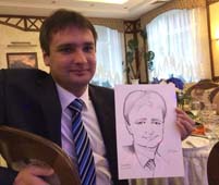 Игорь держит свой шарж на свадьбе в 